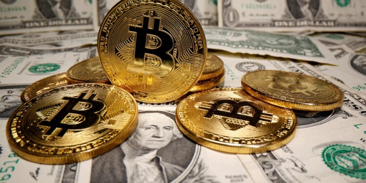 FILE PHOTO: Representations of virtual currency Bitcoin are placed on U.S. Dollar banknotes in this illustration taken May 26, 2020. REUTERS/Dado Ruvic/File Photo