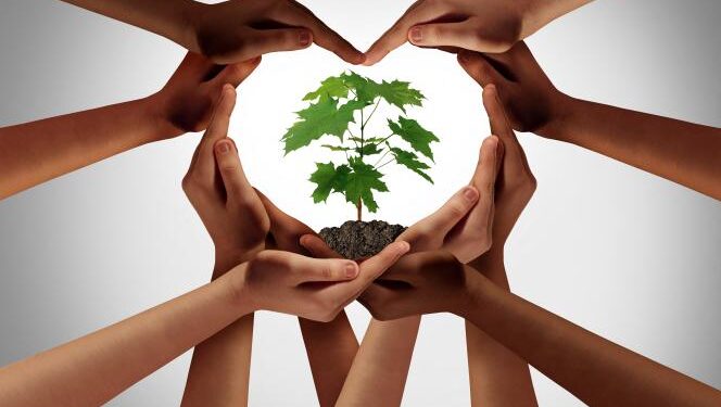 L’écologie entre les mains du dialogue 1 - Le Progrès Egyptien Earthday or earth day as group of diverse people joining to form heart hands connected together protecting the environment and promoting conservation and climate change issues as an image composite.