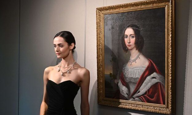 Mandatory Credit: Photo by Vernon Yuen/Shutterstock (12503409c) A model wearing the Queen Joséphine Necklace poses next to a painting in Sotheby's auction house during a press viewing in Hong Kong Sotheby's Auction House Press Viewing, Hong Kong - 29 Sep 2021/shutterstock_editorial_Sotheby_s_Auction_House_Press_12503409c//2109291253