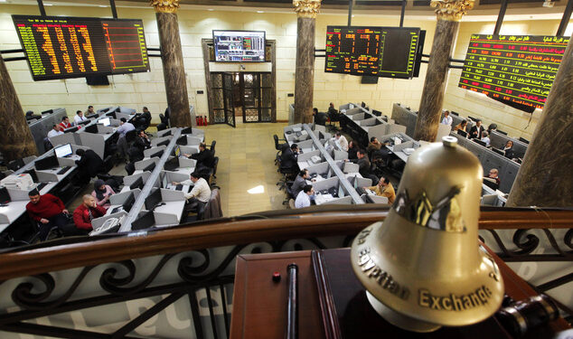 FILE - In this Saturday, March 10, 2013 file photo, Egyptian traders work on the floor of the stock market in Cairo, Egypt. On Sunday, June 1, 2014, Egypts benchmark index plunged, with a temporary suspension of trading failing to cool a frenzy of selling by investors panicked by a newly proposed government tax on capital gains. The market slide was sparked by an announcement from the finance minister that the government will impose a 10 percent tax on net realized portfolio profit at year end. Profits from the stock market are currently tax-free. (AP Photo/Amr Nabil, File)
