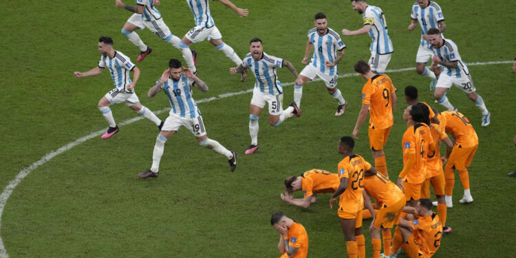 Argentina players celebrate at the end of the World Cup quarterfinal soccer match between the Netherlands and Argentina, at the Lusail Stadium in Lusail, Qatar, Saturday, Dec. 10, 2022. (AP Photo/Thanassis Stavrakis)