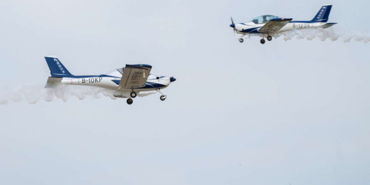 (220901) -- CHANGSHA, Sept. 1, 2022 (Xinhua) -- Two fixed-wing aircraft perform during an air show, which is a part of the 2022 Hunan (International) General Aviation Industry Expo, at the Lusong Airport of Zhuzhou City, central China's Hunan Province, Sept. 1, 2022. The 2022 Hunan (International) General Aviation Industry Expo opened here on Thursday. The expo comprises a static exhibition at the Changsha International Convention and Exhibition Center in Changsha and an air show at the Lusong Airport of Zhuzhou City, both in central China's Hunan Province. (Xinhua/Chen Sihan) (Photo by Chen Sihan / XINHUA / Xinhua via AFP)