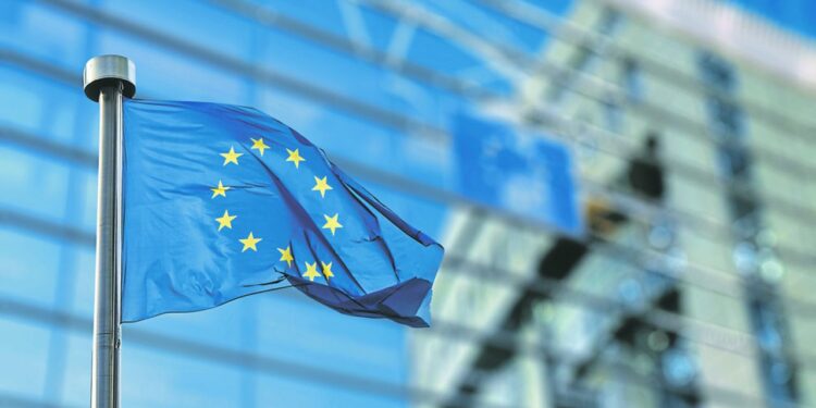 European Union flag in front of the Berlaymont building (European commission) in Brussels, Belgium.