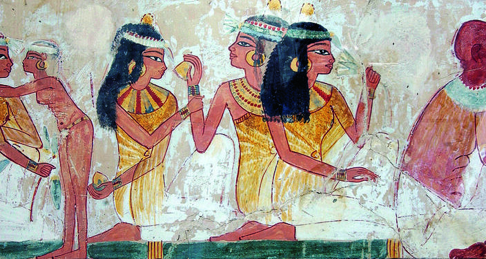 Egypt, New Kingdom, 18th Dynasty, c. 1390 BC.Scene of celebrations: A servant is attending to 3 ladies: One holding a mandrake root, another a lotus flower, harpist.– Detail from the “Celebration of the Valley”. Wall painating, tomb of Nacht / Nakht (TT 52), necropolis of Sheikh Abd el-Qurna, Thebes (Egypt).–